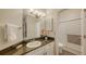 Bright bathroom featuring granite countertops, framed mirror, and white cabinets at 4423 Park Lake N Ter, Bradenton, FL 34209