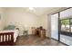 Bedroom with a desk and sliding door to the patio with tile flooring at 4423 Park Lake N Ter, Bradenton, FL 34209
