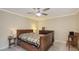 Cozy bedroom with a ceiling fan, dark wood furniture, and a colorful quilt on the bed at 4423 Park Lake N Ter, Bradenton, FL 34209
