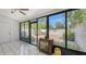 Bright Florida room featuring tile floors, large windows, and access to the outdoor patio at 4423 Park Lake N Ter, Bradenton, FL 34209
