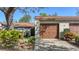 This home features a one-car garage with a brown door and well-maintained landscaping at 4423 Park Lake N Ter, Bradenton, FL 34209