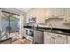 Bright kitchen with white cabinetry, stainless steel appliances, and access to an outdoor patio at 4423 Park Lake N Ter, Bradenton, FL 34209