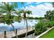 Scenic lake view from the wooden dock framed by palm trees and greenery at 4423 Park Lake N Ter, Bradenton, FL 34209