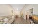 Open-concept living area with hardwood floors, vaulted ceiling, dining area, and view to additional room at 4423 Park Lake N Ter, Bradenton, FL 34209