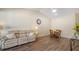 Bright living room featuring hardwood floors, a vaulted ceiling, and a comfortable leather sofa at 4423 Park Lake N Ter, Bradenton, FL 34209