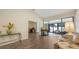 Living room featuring hardwood floors and large sliding glass doors leading to the Florida room at 4423 Park Lake N Ter, Bradenton, FL 34209