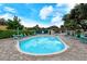 Inviting community pool with lounge chairs, umbrellas, and a well-maintained surrounding area at 4423 Park Lake N Ter, Bradenton, FL 34209