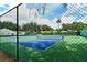 Community tennis courts featuring well-maintained blue and green surfaces, surrounded by secure fencing and lush landscaping at 4423 Park Lake N Ter, Bradenton, FL 34209