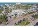 Aerial view of commercial buildings with palm trees lining the street at 4822 Ocean Blvd # 11E, Sarasota, FL 34242