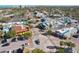 Aerial view of a roundabout with colorful commercial buildings and lush trees at 4822 Ocean Blvd # 11E, Sarasota, FL 34242