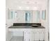 Bright bathroom featuring an extended countertop, vanity, and a large, well-lit mirror at 4822 Ocean Blvd # 11E, Sarasota, FL 34242