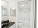 Well-lit bathroom featuring white tiled walls and a shower-tub combo at 4822 Ocean Blvd # 11E, Sarasota, FL 34242