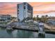Modern condo with a private pool and canal access, with vibrant sky at sunset at 4822 Ocean Blvd # 11E, Sarasota, FL 34242