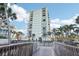 Modern high-rise condo building with balconies surrounded by lush greenery at 4822 Ocean Blvd # 11E, Sarasota, FL 34242