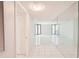 Inviting hallway with natural light and expansive mirror reflecting space at 4822 Ocean Blvd # 11E, Sarasota, FL 34242