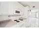 Functional kitchen with classic white cabinetry and essential appliances at 4822 Ocean Blvd # 11E, Sarasota, FL 34242