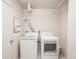 Functional laundry room with modern side-by-side washer and dryer units at 4822 Ocean Blvd # 11E, Sarasota, FL 34242