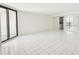 Bright living room featuring sliding glass doors and tile flooring throughout at 4822 Ocean Blvd # 11E, Sarasota, FL 34242