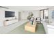 Bright living room with modern decor and glass sliding door to a balcony, staged for appeal at 4822 Ocean Blvd # 11E, Sarasota, FL 34242