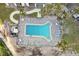 Aerial view of the community pool surrounded by lounge chairs and palm trees at 4822 Ocean Blvd # 11E, Sarasota, FL 34242