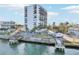 Waterfront condominium complex featuring a pool and dock, with lush palm trees at 4822 Ocean Blvd # 11E, Sarasota, FL 34242