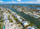 Stunning aerial view of waterfront property featuring lush landscaping, private dock, and canal access to the open bay at 511 68Th St, Holmes Beach, FL 34217