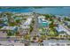 An aerial view of a charming beach town, with colorful buildings and lush palm trees lining the streets at 511 68Th St, Holmes Beach, FL 34217