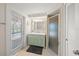 Bathroom with a vanity with double sinks, tile shower, and access to the pool area at 511 68Th St, Holmes Beach, FL 34217