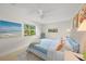 Bedroom features bright artwork, ceiling fan, and window with view of lush landscaping at 511 68Th St, Holmes Beach, FL 34217