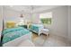 Bright bedroom with two twin beds, neutral tile, and an anchor decoration on the wall at 511 68Th St, Holmes Beach, FL 34217
