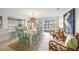Cozy dining area with modern lighting, seating for six, and seamless access to the outdoor pool at 511 68Th St, Holmes Beach, FL 34217
