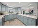 Modern kitchen with bright blue cabinets, white countertops, and stainless steel appliances at 511 68Th St, Holmes Beach, FL 34217