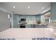 Well-lit kitchen with white countertops, blue cabinets, and stainless steel appliances at 511 68Th St, Holmes Beach, FL 34217