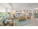 Bright living room with comfortable seating, stylish decor, and a ceiling fan at 511 68Th St, Holmes Beach, FL 34217