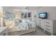 Bright main bedroom features white furnishings, water view, and flat screen TV on dresser at 511 68Th St, Holmes Beach, FL 34217