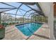 Pool area with brick paver patio and views of the lush landscaping and canal at 511 68Th St, Holmes Beach, FL 34217