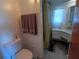 Bathroom featuring a toilet, cabinet, and bathtub with shower at 5235 Cherry Hill Ave, Sarasota, FL 34234