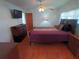 This comfortable bedroom has a queen bed, ceiling fan, dresser, and window with lots of light at 5235 Cherry Hill Ave, Sarasota, FL 34234