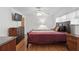 This bright bedroom has wood floors and a closet and dresser for storage at 5235 Cherry Hill Ave, Sarasota, FL 34234