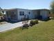 Well-kept single-story home with a tidy landscape and extended covered parking with additional space at 5235 Cherry Hill Ave, Sarasota, FL 34234