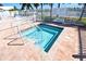 Community hot tub for relaxing, with an easy access ladder, safety rules posted, and surrounded by a white picket fence at 5235 Cherry Hill Ave, Sarasota, FL 34234