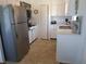 Well-lit kitchen featuring stainless steel refrigerator and white cabinetry at 5235 Cherry Hill Ave, Sarasota, FL 34234