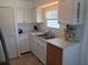 Bright kitchen featuring white cabinets, double sink, and stylish countertops at 5235 Cherry Hill Ave, Sarasota, FL 34234