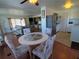 Living room with a stylish table, sofa, and a dining table with four chairs at 5235 Cherry Hill Ave, Sarasota, FL 34234