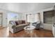 Comfortable living room featuring a sofa, armchair, and plenty of natural light at 5235 Cherry Hill Ave, Sarasota, FL 34234