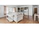 Spacious living room featuring modern furniture and light hardwood floors at 5235 Cherry Hill Ave, Sarasota, FL 34234
