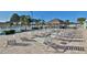 Relaxing poolside area with a shaded tiki hut, lined by rows of seating and palm trees at 5235 Cherry Hill Ave, Sarasota, FL 34234