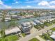 Aerial view of home under construction in waterfront neighborhood with canal access and coastal views at 525 68Th St St, Holmes Beach, FL 34217