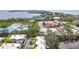 Real estate aerial view of houses near a water feature and a church at 534 Sutton Pl, Longboat Key, FL 34228