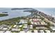 Wide aerial view of a coastal community with lush landscaping, serene ponds and quick access to beautiful beaches at 534 Sutton Pl, Longboat Key, FL 34228